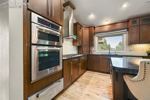 1282 Hill Cir, Colorado Springs, CO 80904 - kitchen with appliances with stainless steel finishes, a warming drawer, tasteful backsplash, dark stone counters, and light wood-type flooring