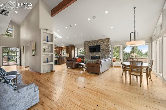 1282 Hill Cir, Colorado Springs, CO 80904 - living area with high vaulted ceiling, light wood-style floors, a stone fireplace, and recessed lighting