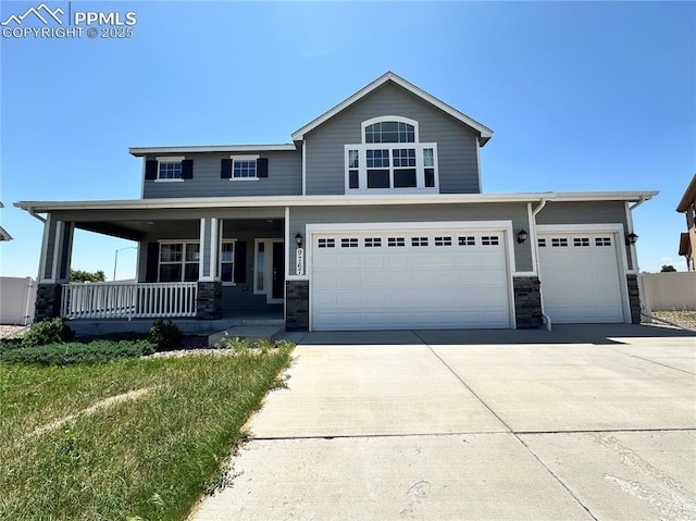 9767 Carnival Ln, Fountain, CO 80817 - view of front facade with a porch, concrete driveway, stone siding, and an attached garage