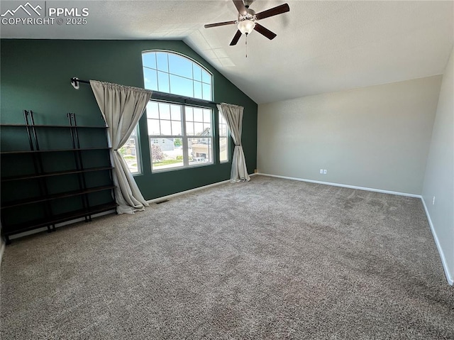 9767 Carnival Ln, Fountain, CO 80817 - carpeted empty room featuring vaulted ceiling, ceiling fan, and a textured ceiling