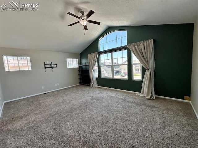 9767 Carnival Ln, Fountain, CO 80817 - carpeted spare room featuring a ceiling fan, healthy amount of natural light, vaulted ceiling, and a textured ceiling