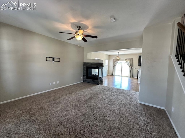 9767 Carnival Ln, Fountain, CO 80817 - unfurnished living room featuring carpet, a ceiling fan, stairway, and a multi sided fireplace