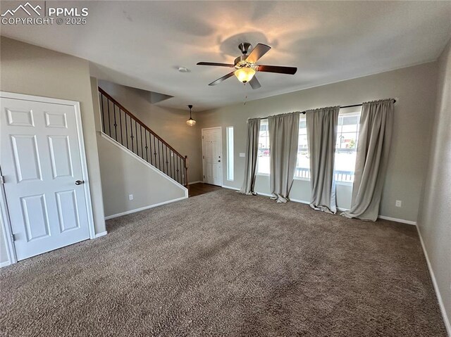 9767 Carnival Ln, Fountain, CO 80817 - unfurnished living room featuring dark carpet, stairs, and ceiling fan