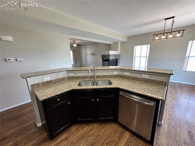 9767 Carnival Ln, Fountain, CO 80817 - kitchen with dishwasher, open floor plan, a multi sided fireplace, dark wood-type flooring, and a ceiling fan