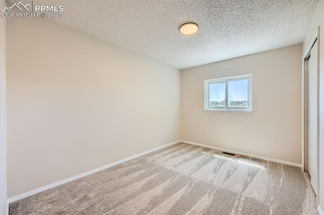 7025 Nettlewood Pl, Colorado Springs, CO 80918 - unfurnished bedroom with carpet floors, a textured ceiling, and a closet