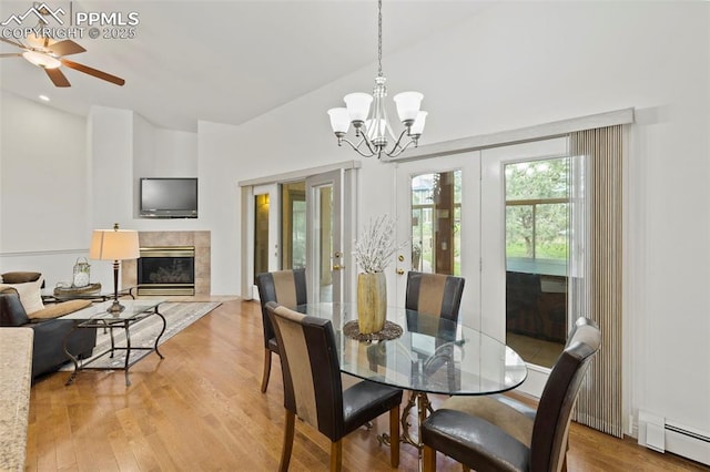 10 Desert Inn Way, Colorado Springs, CO 80921 - dining area featuring a baseboard heating unit, light wood-style floors, a ceiling fan, and a chandelier