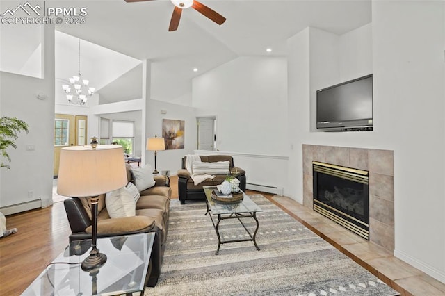 10 Desert Inn Way, Colorado Springs, CO 80921 - living area featuring baseboard heating, a tile fireplace, ceiling fan, high vaulted ceiling, and a chandelier