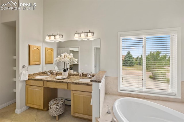 10 Desert Inn Way, Colorado Springs, CO 80921 - bathroom with a garden tub, double vanity, and tile patterned floors