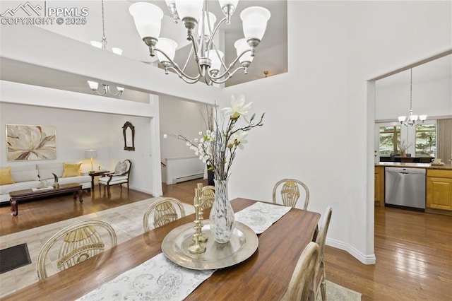 10 Desert Inn Way, Colorado Springs, CO 80921 - dining space with a chandelier, a high ceiling, a baseboard radiator, and dark wood-style floors
