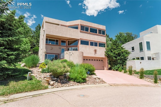 616 Tierra Verde Ct, Colorado Springs, CO 80904 - view of front of house with an attached garage, concrete driveway, and stucco siding