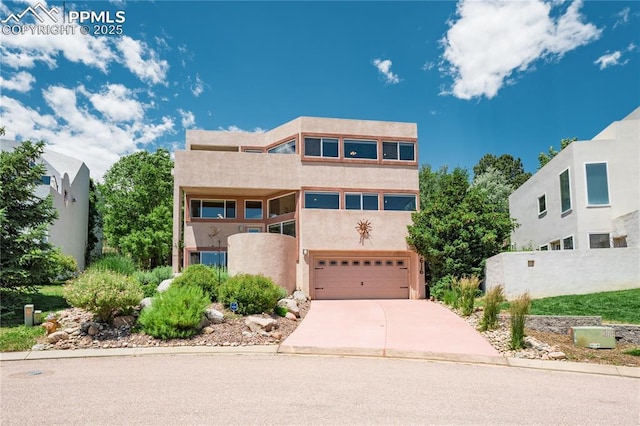 616 Tierra Verde Ct, Colorado Springs, CO 80904 - view of front of property with an attached garage, concrete driveway, and stucco siding