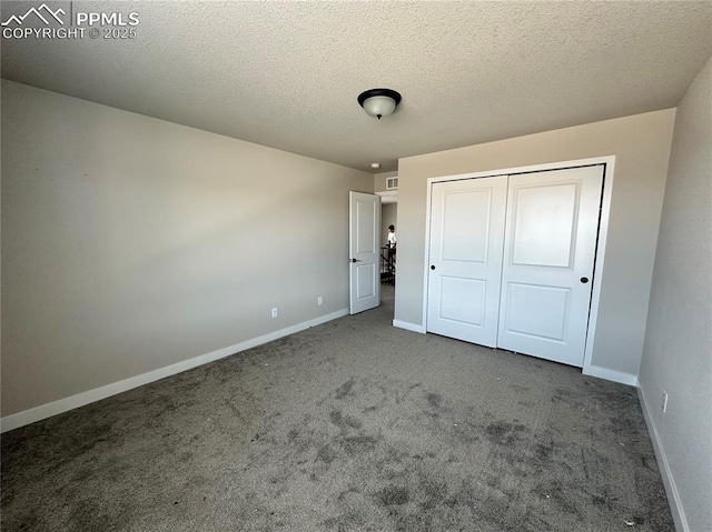 11489 Piping Plover Pl, Colorado Springs, CO 80925 - unfurnished bedroom featuring carpet floors, a closet, and a textured ceiling