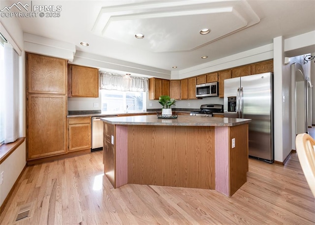 2457 Craycroft Dr, Colorado Springs, CO 80920 - kitchen featuring stainless steel appliances, a center island, light wood finished floors, brown cabinetry, and recessed lighting