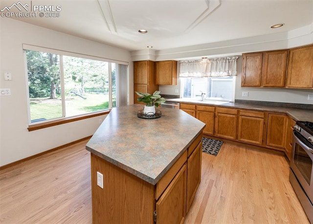 2457 Craycroft Dr, Colorado Springs, CO 80920 - kitchen featuring stainless steel range, brown cabinetry, light wood-style floors, and recessed lighting