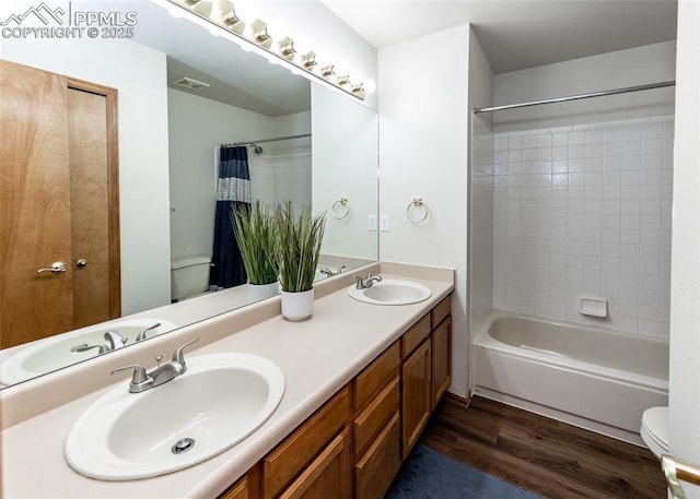 2457 Craycroft Dr, Colorado Springs, CO 80920 - bathroom featuring wood finished floors, double vanity, and washtub / shower combination