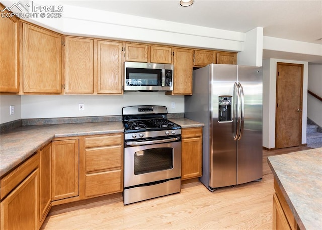 2457 Craycroft Dr, Colorado Springs, CO 80920 - kitchen with stainless steel appliances and light wood-style flooring