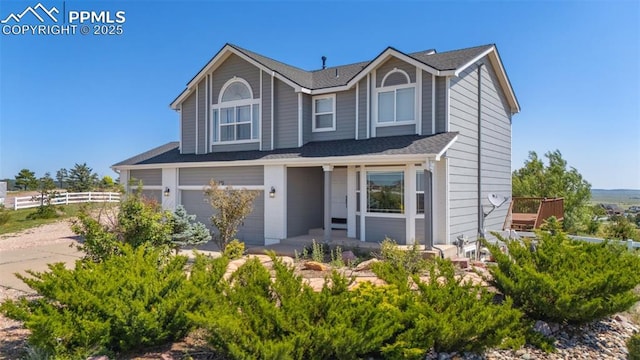 12275 Oregon Wagon Trl, Elbert, CO 80106 - view of front of property with an attached garage, covered porch, and roof with shingles