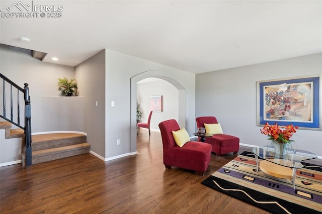 12275 Oregon Wagon Trl, Elbert, CO 80106 - living area with arched walkways, wood finished floors, stairs, and recessed lighting