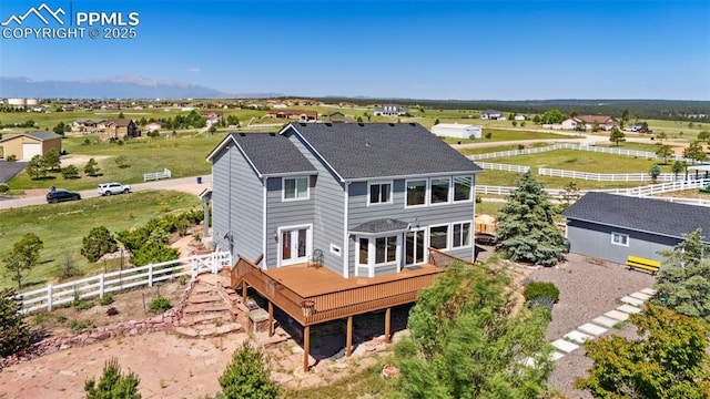 12275 Oregon Wagon Trl, Elbert, CO 80106 - back of house featuring a deck, french doors, roof with shingles, and a view of countryside