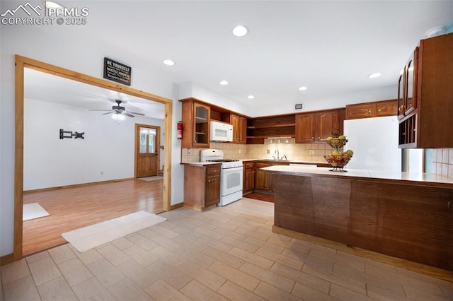 1112 W 4th St, Florence, CO 81226 - kitchen featuring white appliances, open shelves, light countertops, tasteful backsplash, and light wood-style floors