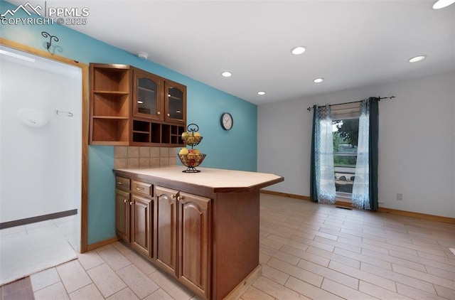 1112 W 4th St, Florence, CO 81226 - kitchen featuring open shelves, recessed lighting, brown cabinets, glass insert cabinets, and decorative backsplash
