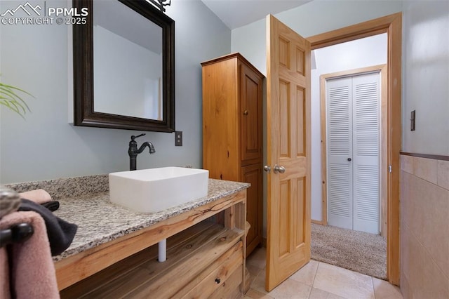 1112 W 4th St, Florence, CO 81226 - bathroom featuring a closet, vanity, and tile patterned flooring