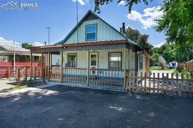 1112 W 4th St, Florence, CO 81226 - view of front of home with board and batten siding and a porch