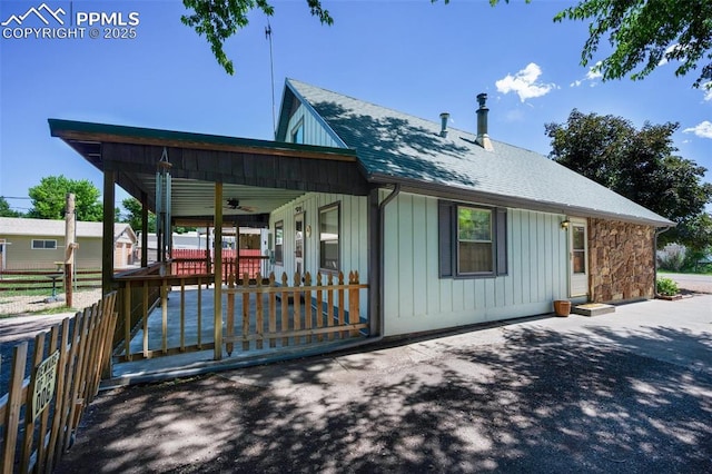 1112 W 4th St, Florence, CO 81226 - rear view of house with ceiling fan, a shingled roof, and board and batten siding