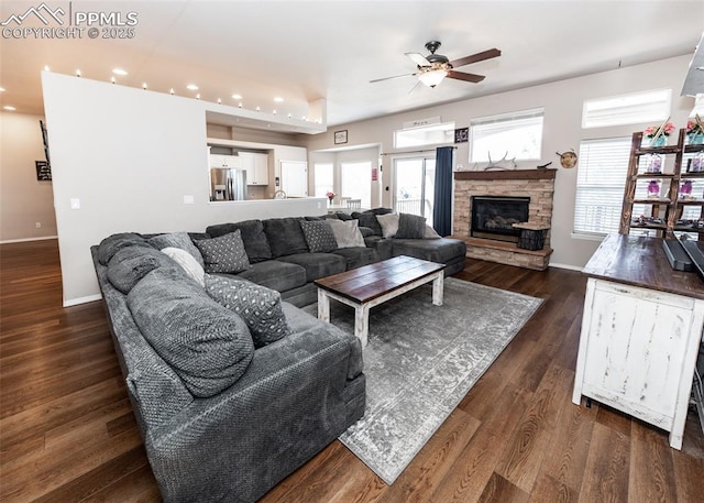 7145 Appletree Loop, Colorado Springs, CO 80925 - living room featuring a ceiling fan, recessed lighting, dark wood-style floors, and a stone fireplace