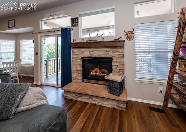 7145 Appletree Loop, Colorado Springs, CO 80925 - living room featuring wood finished floors and a stone fireplace