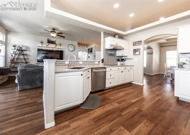 7145 Appletree Loop, Colorado Springs, CO 80925 - kitchen with stainless steel dishwasher, arched walkways, a ceiling fan, a peninsula, and white cabinets