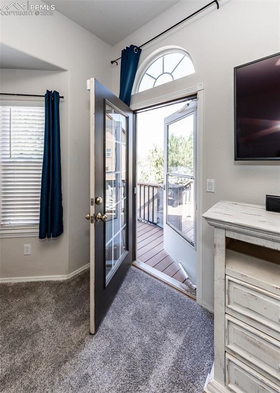 7145 Appletree Loop, Colorado Springs, CO 80925 - doorway to outside featuring carpet and baseboards