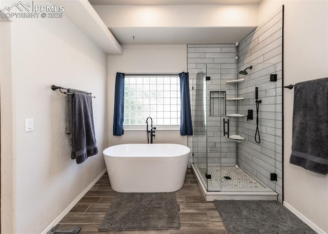 7145 Appletree Loop, Colorado Springs, CO 80925 - bathroom featuring a freestanding bath, a stall shower, and wood finished floors