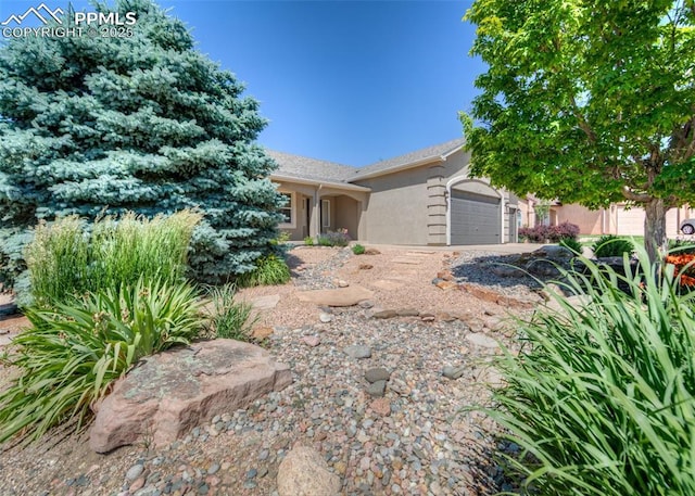7145 Appletree Loop, Colorado Springs, CO 80925 - view of front of property featuring a garage and stucco siding