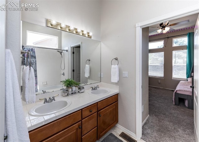 7145 Appletree Loop, Colorado Springs, CO 80925 - ensuite bathroom featuring double vanity, a ceiling fan, and  shower combination