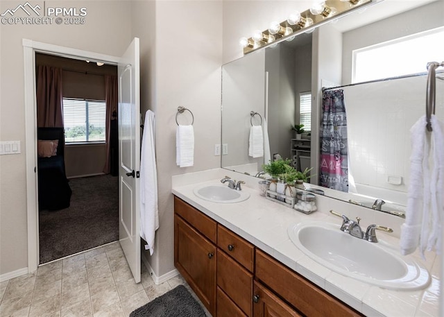 7145 Appletree Loop, Colorado Springs, CO 80925 - bathroom featuring double vanity and shower / bath combo with shower curtain