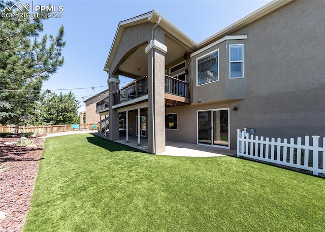 7145 Appletree Loop, Colorado Springs, CO 80925 - rear view of house featuring a balcony, stucco siding, and a patio