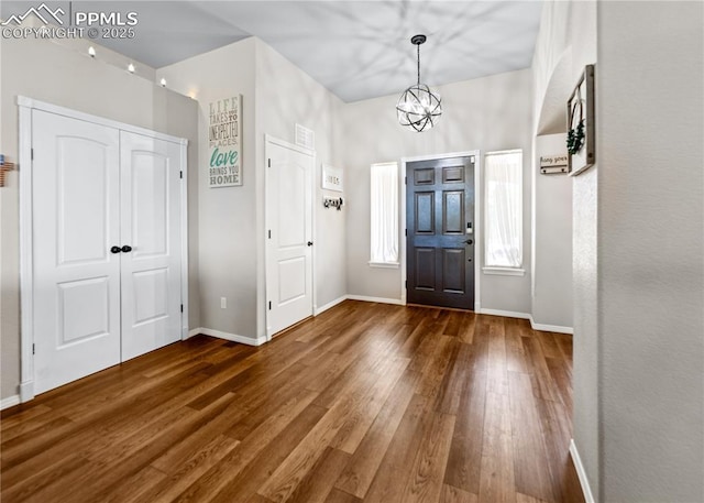 7145 Appletree Loop, Colorado Springs, CO 80925 - entryway with wood finished floors and a chandelier