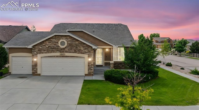 6107 Adamants Dr, Colorado Springs, CO 80924 - view of front of property featuring stone siding, a garage, a front lawn, and driveway