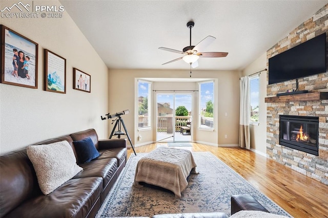 6107 Adamants Dr, Colorado Springs, CO 80924 - living room featuring wood finished floors, healthy amount of natural light, ceiling fan, and a stone fireplace