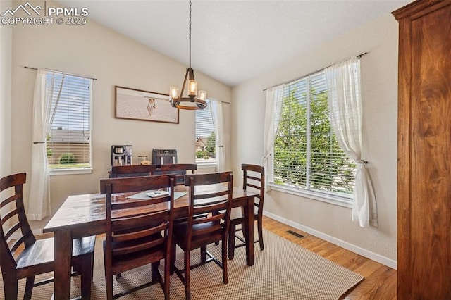 6107 Adamants Dr, Colorado Springs, CO 80924 - dining room with lofted ceiling, light wood-type flooring, and a chandelier