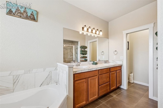 6107 Adamants Dr, Colorado Springs, CO 80924 - full bathroom featuring double vanity, a stall shower, tile patterned flooring, and a garden tub