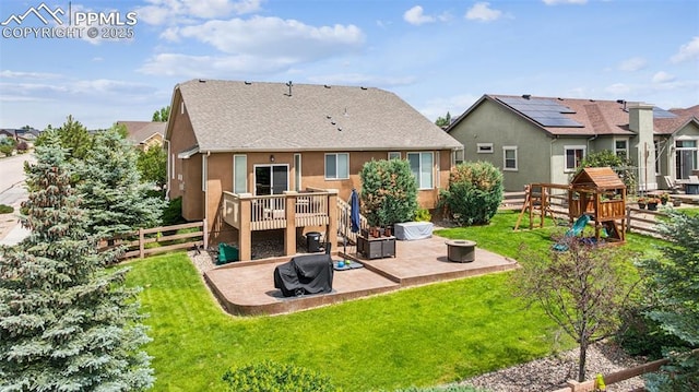 6107 Adamants Dr, Colorado Springs, CO 80924 - back of house featuring a patio area, stucco siding, a playground, roof with shingles, and a fire pit