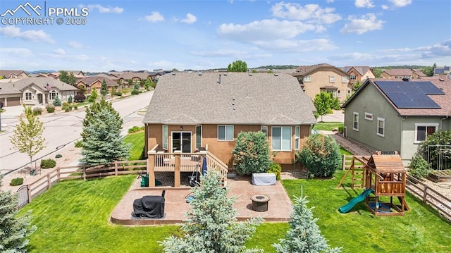 6107 Adamants Dr, Colorado Springs, CO 80924 - back of property featuring a fire pit, a residential view, a fenced backyard, roof with shingles, and a patio area