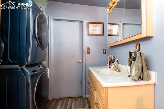 12185 Black Forest Rd, Colorado Springs, CO 80908 - laundry room with stacked washing machine and dryer and dark wood-style floors