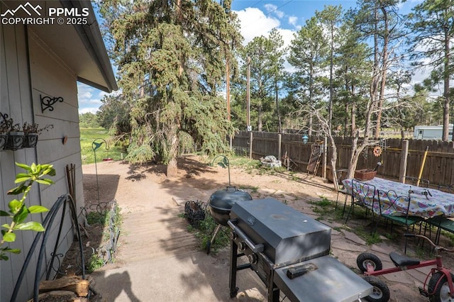 12185 Black Forest Rd, Colorado Springs, CO 80908 - view of patio with a grill and view of wooded area