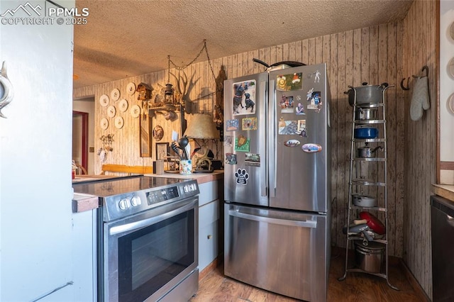 12185 Black Forest Rd, Colorado Springs, CO 80908 - kitchen featuring stainless steel appliances, a textured ceiling, and wood finished floors