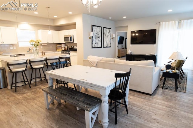 8176 Kittrick Pl, Peyton, CO 80831 - dining room featuring light wood-style floors and recessed lighting