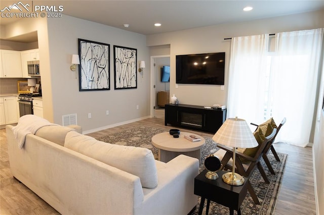 8176 Kittrick Pl, Peyton, CO 80831 - living area with light wood-style flooring and recessed lighting