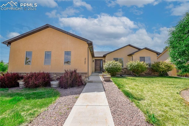 5707 Mark Twain Ln, Pueblo, CO 81008 - view of front of home with a front yard, stucco siding, and stone siding